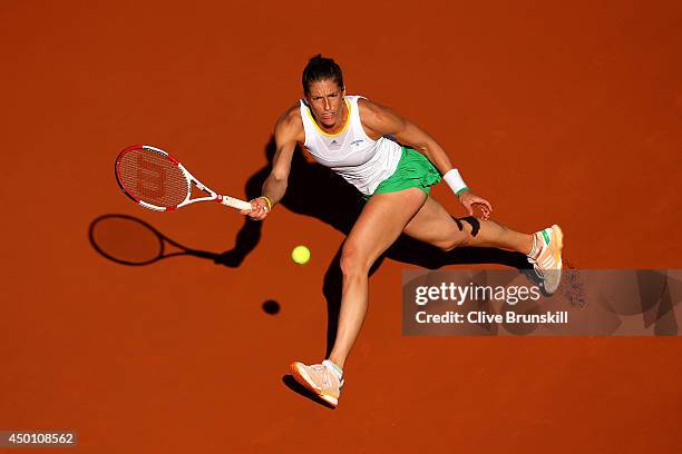 Andrea Petkovic of Germany returns a shot during her women's singles match against Simona Halep of Romania on day twelve of the French Open at Roland...