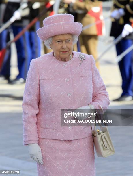 Britain's Queen Elizabeth II pays her respects during a ceremony with the French President during which they laid a wreath on the Tomb of the Unknown...