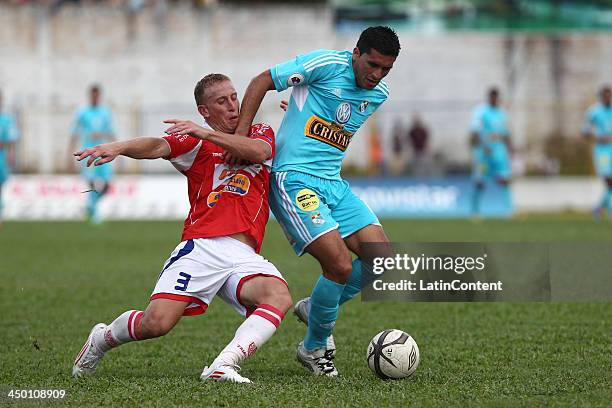 Jesus Alvarez of Sporting Cristal fights for the ball with Joaquin Lencinas of Union Comercio during a match between Union Comercio and Sporting...