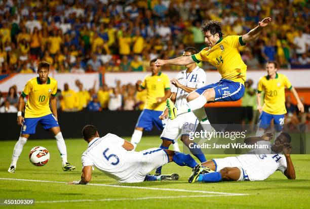 Maxwell of Brazil takes a shot on goal in front of Lucas Leiva of Honduras in the first half during a friendly match at Sun Life Stadium on November...