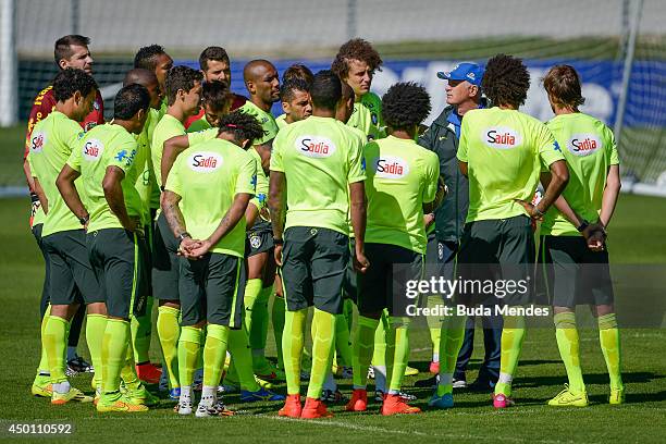 Head coach Luiz Felipe Scolari speaks with his players during a training session of the Brazilian national football team at the squad's Granja Comary...