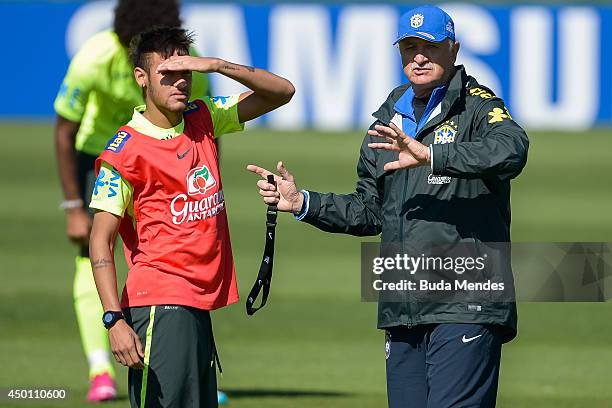 Head coach Luiz Felipe Scolari speaks with a Neymar during a training session of the Brazilian national football team at the squad's Granja Comary...