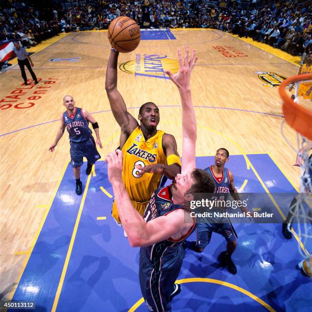 Kobe Bryant of the Los Angeles Lakers dunks against Todd MacCulloch of the New Jersey Nets during Game One of the 2002 NBA Finals on June 5, 2002 at...