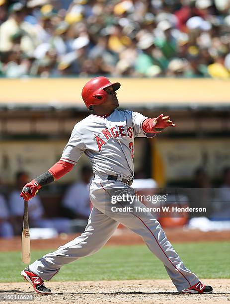 Erick Aybar of the Los Angeles Angels of Anaheim hits a sacrifice fly scoring Collin Cowgill in the top of the fifth inning against the Oakland...