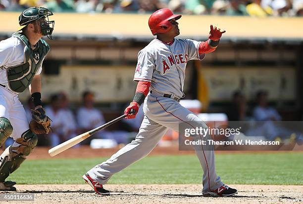 Erick Aybar of the Los Angeles Angels of Anaheim hits a sacrifice fly scoring Collin Cowgill in the top of the fifth inning against the Oakland...