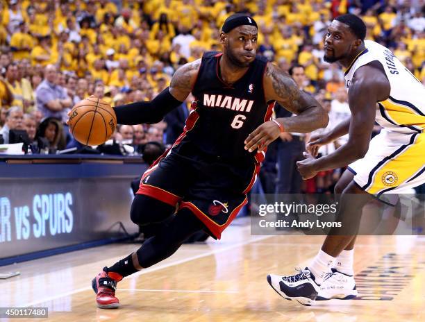 LeBron James of the Miami Heat drives to the basket against Lance Stephenson of the Indiana Pacers during Game Five of the Eastern Conference Finals...