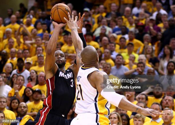 Dwyane Wade of the Miami Heat takes a shot over David West of the Indiana Pacers during Game Five of the Eastern Conference Finals of the 2014 NBA...