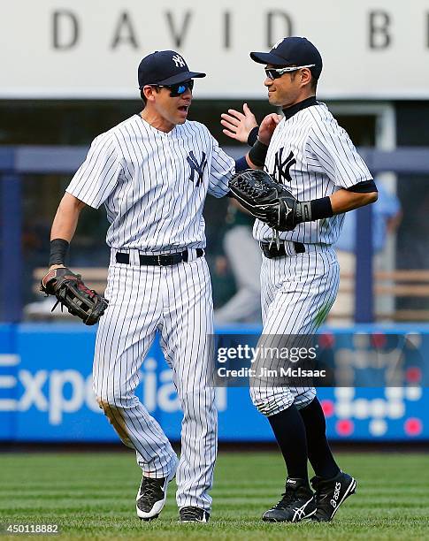 Jacoby Ellsbury and Ichiro Suzuki of the New York Yankees celebrate after defeating the Oakland Athletics at Yankee Stadium on June 5, 2014 in the...
