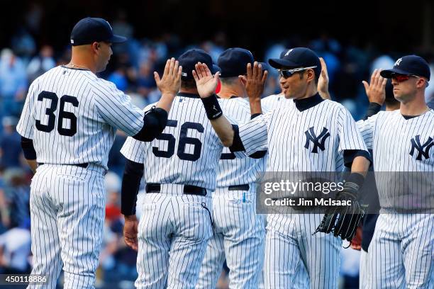 Ichiro Suzuki of the New York Yankees celebrates after defeating the Oakland Athletics with teammate Carlos Beltran at Yankee Stadium on June 5, 2014...