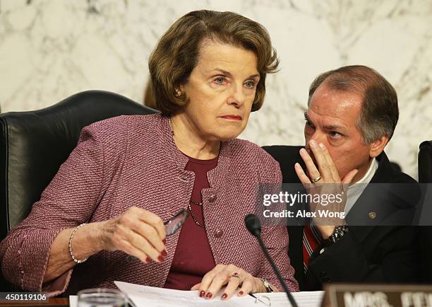 Committee chairman Sen. Dianne Feinstein listens to an aide during a hearing before the Senate Intelligence Committee June 5, 2014 on Capitol Hill in...