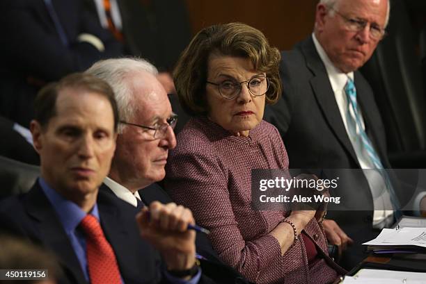 Sen. Ron Wyden , Sen. John Rockefeller , committee chairman Sen. Dianne Feinstein , and ranking member Sen. Saxby Chambliss listen during a hearing...