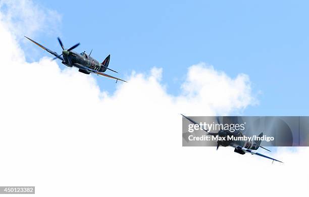 Two Spitfires take part in a fly-past over Pegasus Bridge during the D-Day 70 Commemorations on June 5, 2014 in Ranville, France. Friday 6th June is...