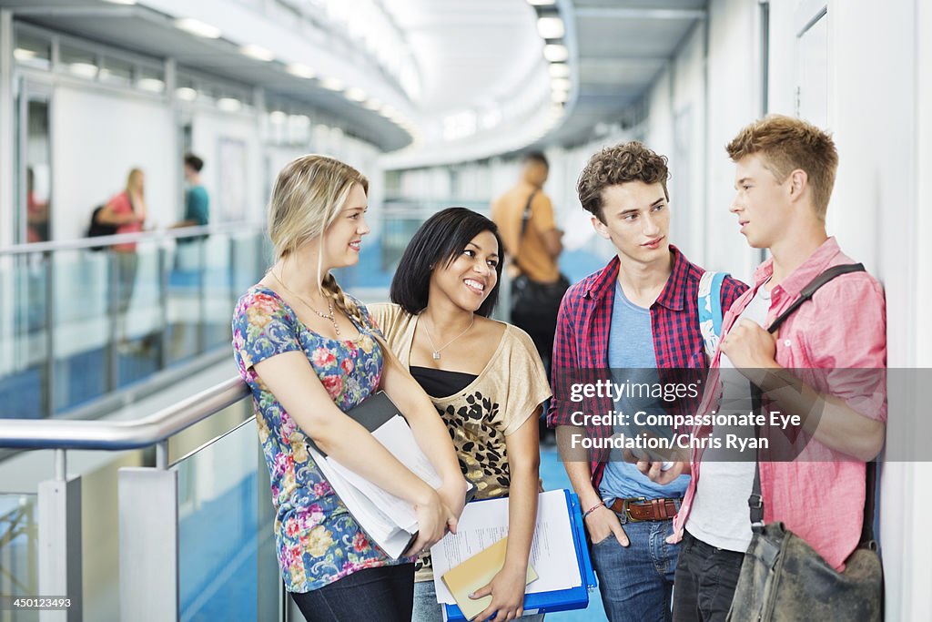Smiling college students standing in hallway
