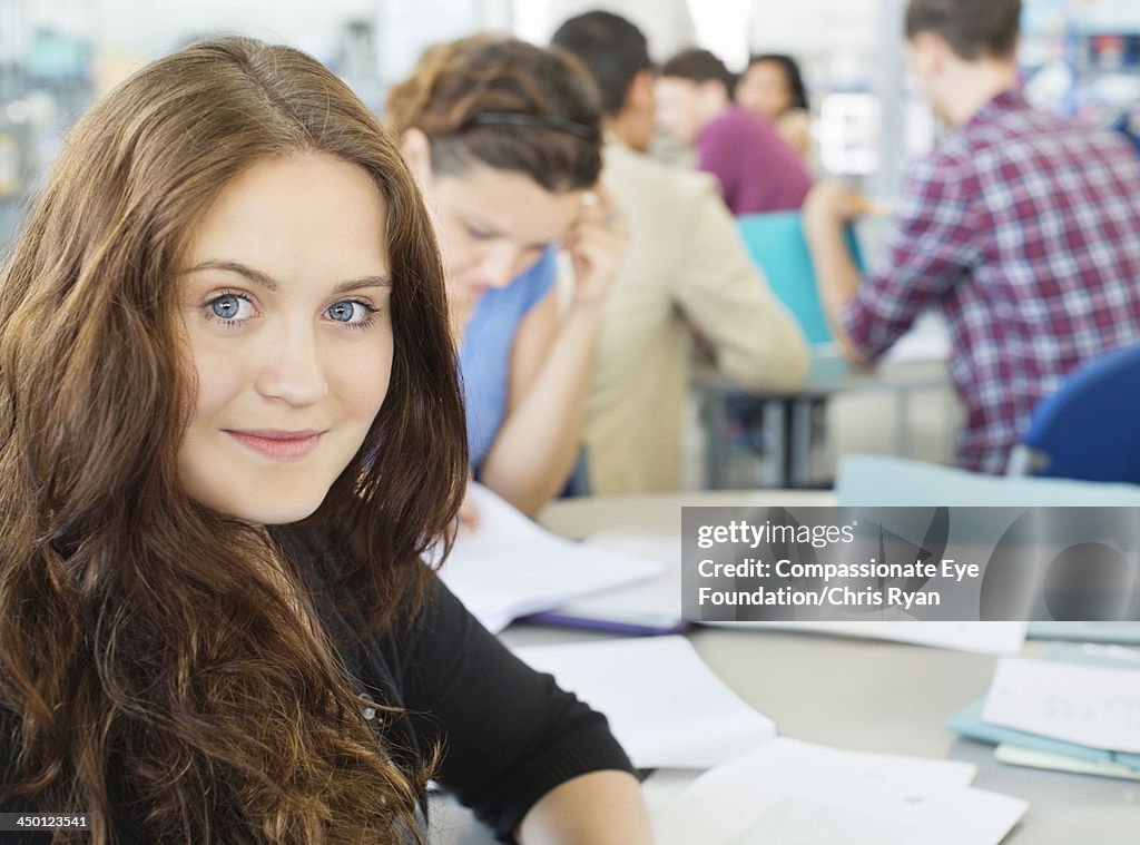 College students writing in classroom