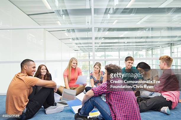 college students relaxing in hallway - boy and girl talking stock-fotos und bilder