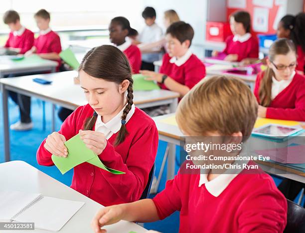 Students Using Paper Students Folding Coloured Paper In Classroom High-Res Stock Photo ...