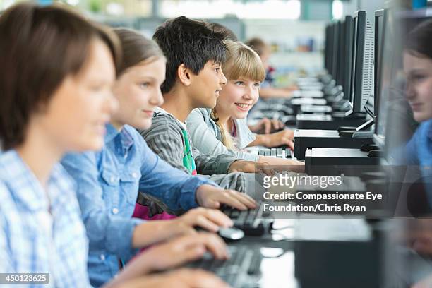 students using computers in classroom - technology education stock pictures, royalty-free photos & images