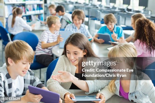 Students using digital tablets in classroom Students using digital tablets in classroom