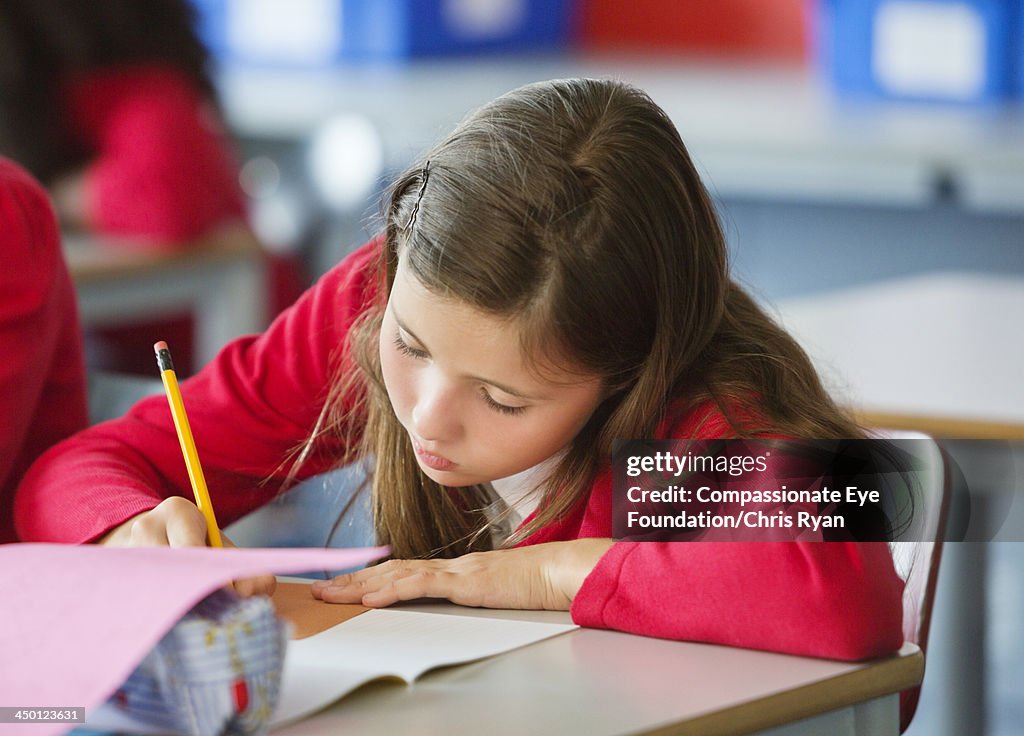 Student writing in classroom