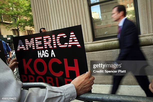 Activists hold a protest near the Manhattan apartment of billionaire and Republican financier David Koch on June 5, 2014 in New York City. The...