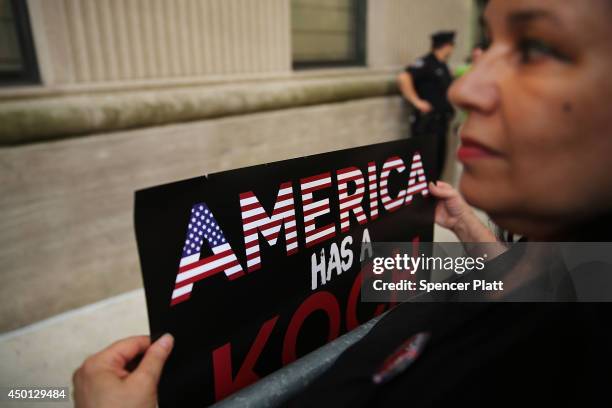 Activists hold a protest near the Manhattan apartment of billionaire and Republican financier David Koch on June 5, 2014 in New York City. The...