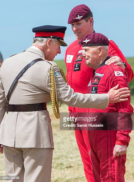 Prince Charles, Prince of Wales greets 88 year old D-Day Veteran Jock Hutton after he completed a parachute jump just outside Rainville during D-Day...