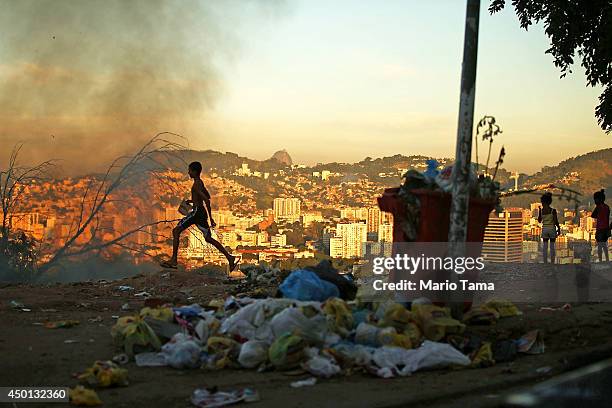 Trash fire burns due to the lack of government assistance of trash disposal in the Mangueira community, or 'favela', which overlooks the famed...