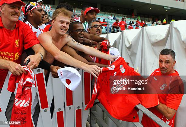 Fans with John Aldridge during the Legends match between Liverpool FC Legends and Kaizer Chiefs Legends at Moses Mabhida Stadium on November 16, 2013...