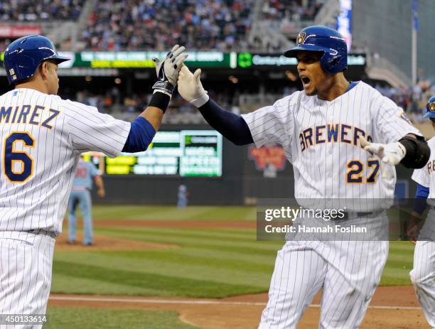 Carlos Gomez of the Milwaukee Brewers is congratulated by Aramis Ramirez on his three-run home run against the Minnesota Twins during the fourth...