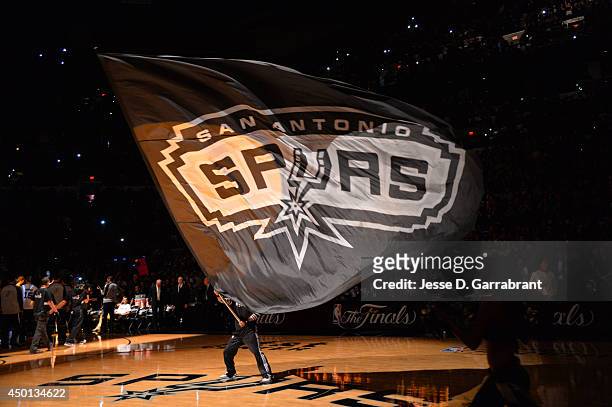 Mascot of the San Antonio Spurs holds the logo up during a timeout against the Miami Heat during Game One of the 2014 NBA Finals on June 5, 2014 at...
