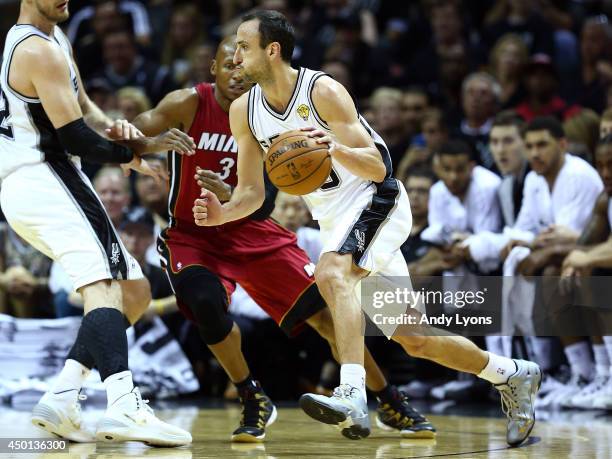 Manu Ginobili of the San Antonio Spurs controls the ball as Ray Allen of the Miami Heat defends during Game One of the 2014 NBA Finals at the AT&T...