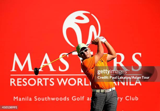 Angelo Que of the Philippines plays a shot during round four of the Resorts World Manila Masters at Manila Southwoods Golf and Country Club on...