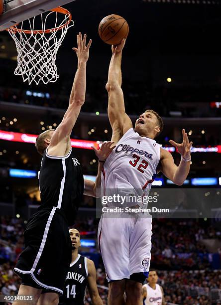 Blake Griffin of the Los Angeles Clippers shoots against Mason Plumlee of the Brooklyn Nets at Staples Center on November 16, 2013 in Los Angeles,...