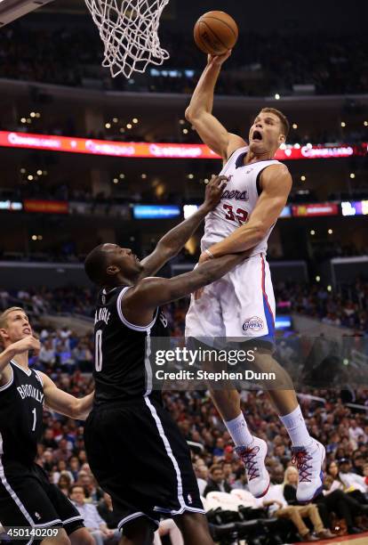 Blake Griffin of the Los Angeles Clippers goes up for a shot and picks up a foul from Andray Blatche of the Brooklyn Nets at Staples Center on...