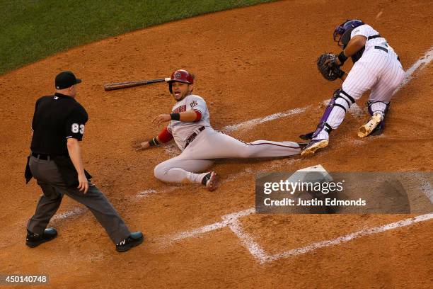 Gerardo Parra of the Arizona Diamondbacks is tagged out by catcher Wilin Rosario of the Colorado Rockies for the third out of the fourth inning as...