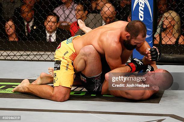 Johny Hendricks punches Georges St-Pierre in their UFC welterweight championship bout during the UFC 167 event inside the MGM Grand Garden Arena on...