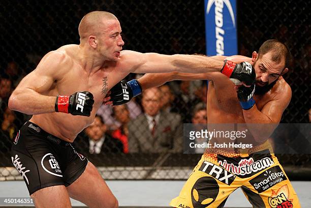 Georges St-Pierre punches Johny Hendricks in their UFC welterweight championship bout during the UFC 167 event inside the MGM Grand Garden Arena on...