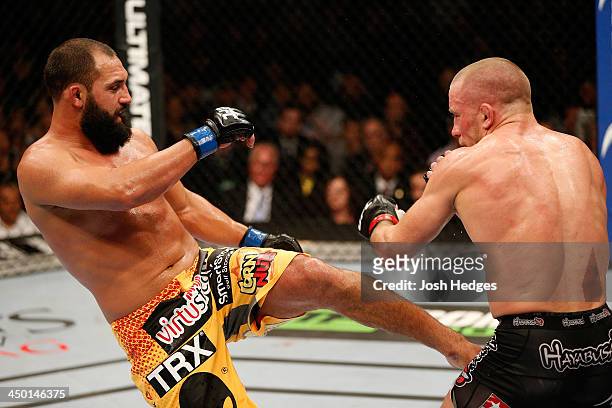 Johny Hendricks kicks Georges St-Pierre in their UFC welterweight championship bout during the UFC 167 event inside the MGM Grand Garden Arena on...