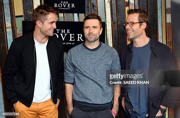 Actors Robert Pattinson , Guy Pearce and director David Michod pose during a photo call for their new movie 'The Rover' in Sydney on June 6, 2014....