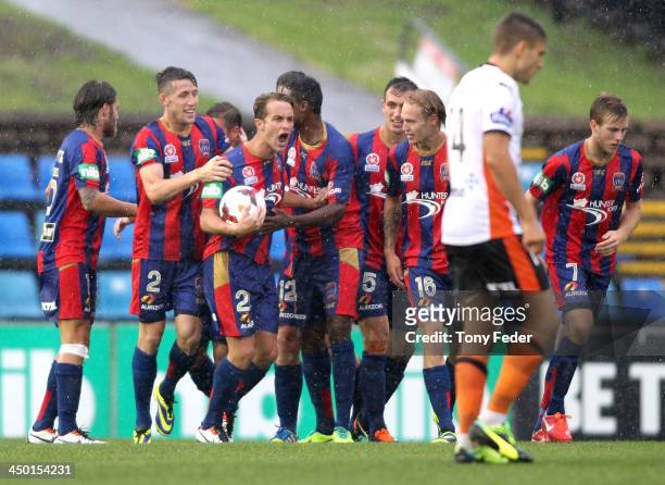 Jets team mates celebrate a goal during the round six A-League match between the Newcastle Jets and Brisbane Roar at Hunter Stadium on November 17,...