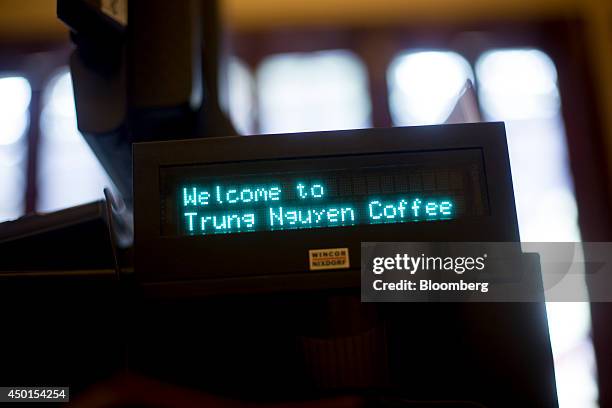 'Welcome to Trung Nguyen Coffee' is displayed on a cash register inside a Trung Nguyen Corp. Coffee store in Hanoi, Vietnam, on Saturday, May 31,...