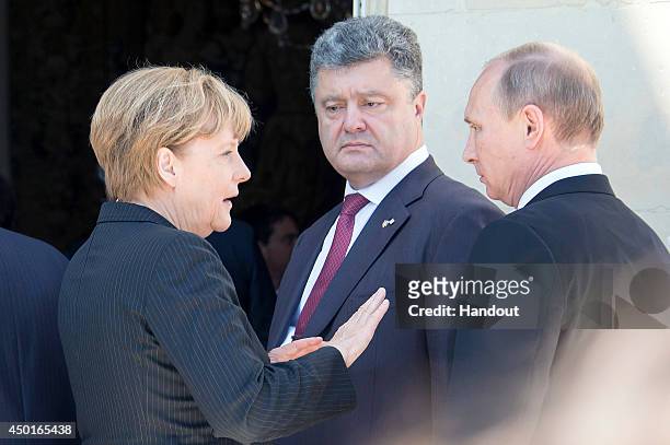 German Chancellor Angela Merkel, Petro Poroshenko and Russian President Vladimir Putin are seen after their lunch on June 6, 2014 in Benouville,...