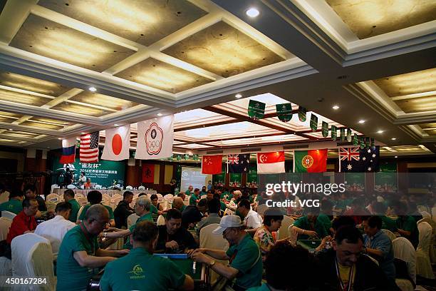 Participants compete during the 2014 World Mahjong Master Invitational Tournament on June 6, 2014 in Kunming, Yunnan Province of China. 143...