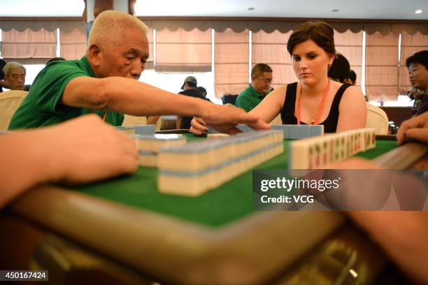 Participants compete during the 2014 World Mahjong Master Invitational Tournament on June 6, 2014 in Kunming, Yunnan Province of China. 143...