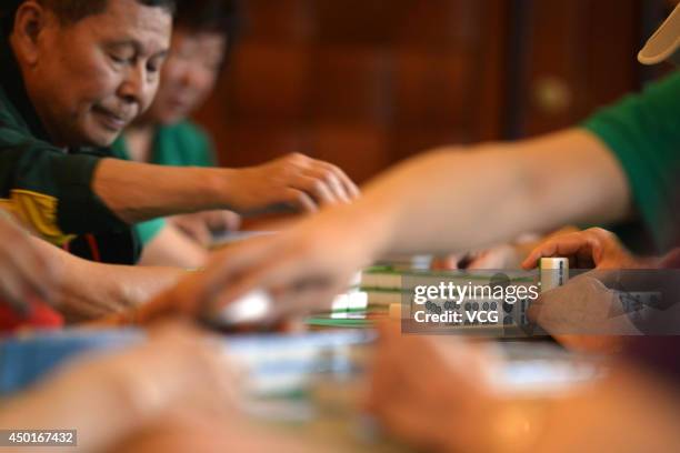 Participants compete during the 2014 World Mahjong Master Invitational Tournament on June 6, 2014 in Kunming, Yunnan Province of China. 143...