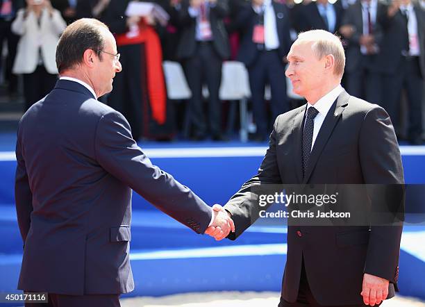 Russian President Vladimir Putin greets President Francois Hollande of France at a Ceremony to Commemorate D-Day 70 on Sword Beach on June 6, 2014 in...