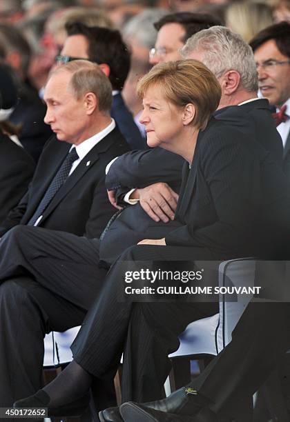 German Chancellor Angela Merkel and Russia's President Vladimir Putin attend an international D-Day commemoration ceremony on the beach of...