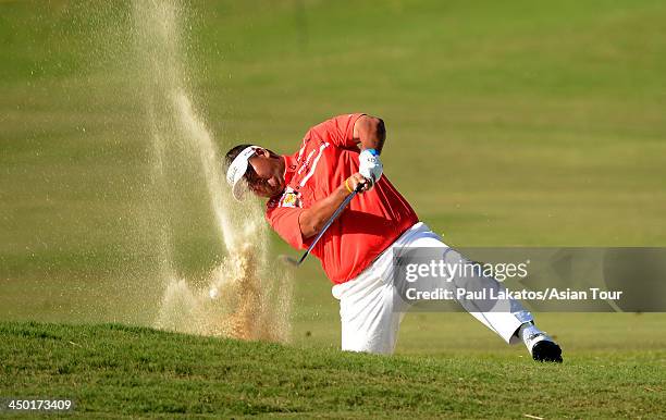 Prom Meesawat of Thailand plays a shot during round four of the Resorts World Manila Masters at Manila Southwoods Golf and Country Club on November...