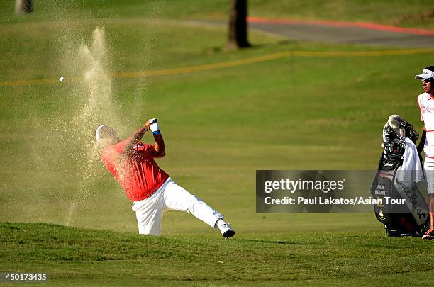 Prom Meesawat of Thailand plays a shot during round four of the Resorts World Manila Masters at Manila Southwoods Golf and Country Club on November...