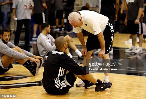 Head coach Gregg Popovich speaks to Tony Parker of the San Antonio Spurs during practice and media availability following Game One of the 2014 NBA...